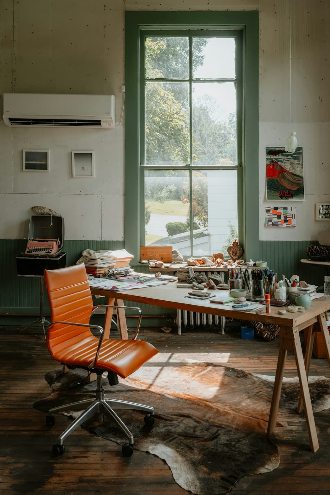Artist's studio with desk, chair, and large window
